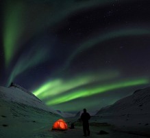 illuminated tent under Northern Lights