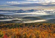 Cat Mountain summit with autumn morning fog over Lake George valley and Black Mt