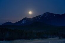 Sprintime full moon setting over Whiteface Mountain 