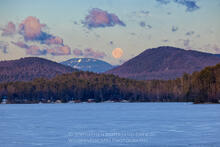 Full moon setting behind Gore Mountain ski area and Schroon Lake from the town of Adirondack