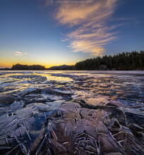Lower Saranac Lake ice shards reflecting spring sunset light