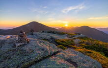 Skylight summit rocks and cairns, Mt Marcy, and sunrise over Basin and Haystack