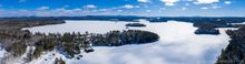 Upper Saranac Lake sunny late winter day drone 180 degree panorama
