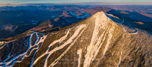 Whiteface Mt slides summit and ski trails sunrise light winter aerial