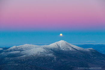 Whiteface Mt with rising full moon over summit winter aerial