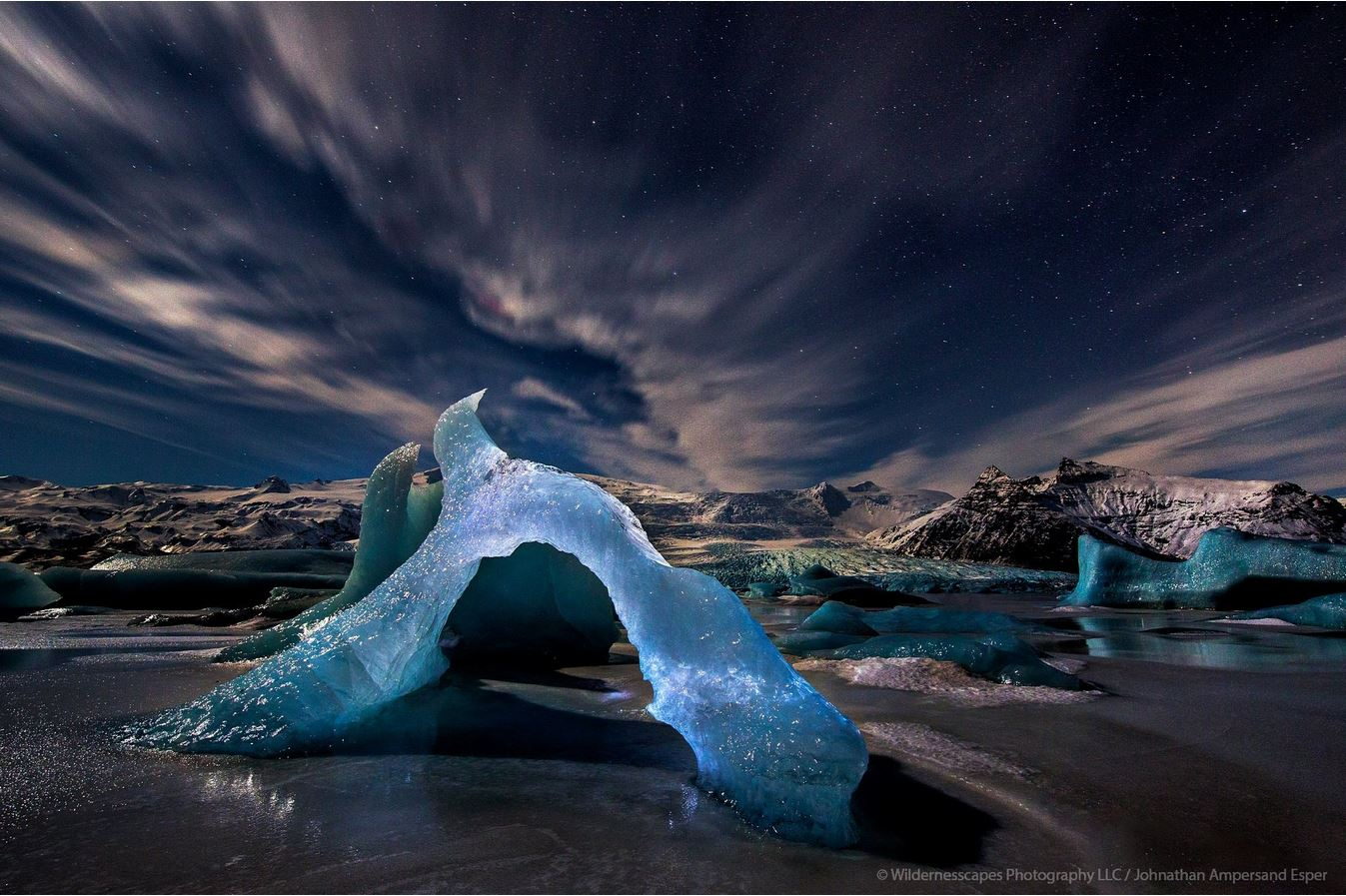 &nbsp;Frozen Fjallsarlon icebergs under stars, moonlight and a little headlamp light, Iceland.