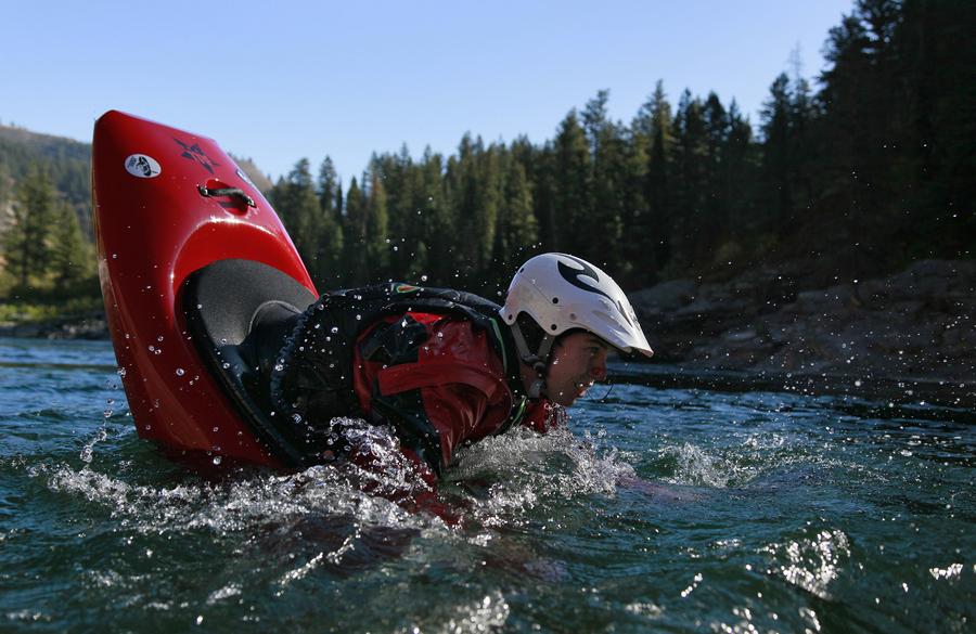 Jonathan Souter performing an ender in prep for a somersault in his white water kayak on the Snake River, Wyoming