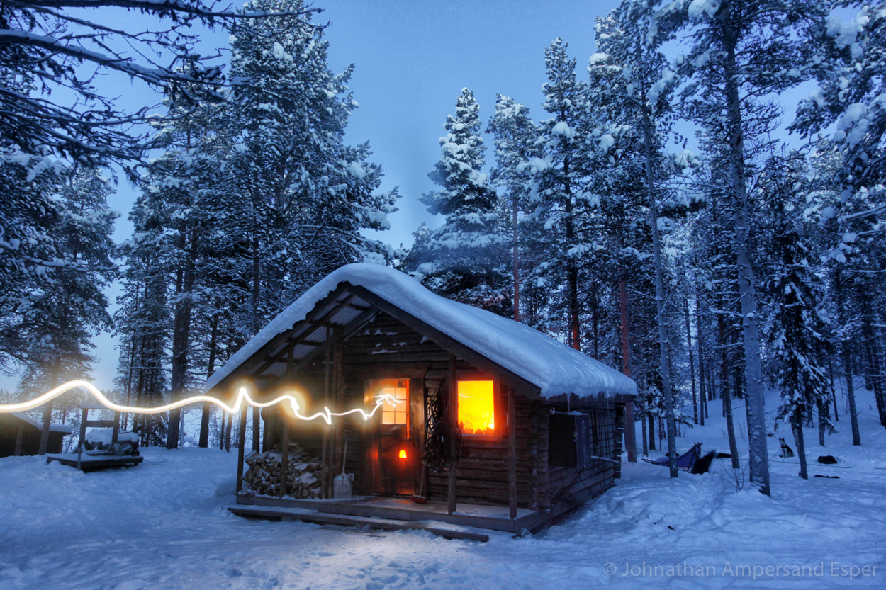A cabin radiating warmth in the snowy forest. Captured on a 10 day dogsledding trip in -30 to -20 degree C temperatures near...