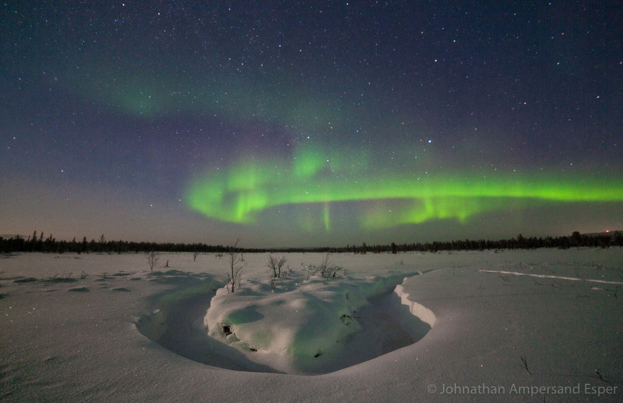 Aurora borealis above the snowy landscape near Kiruna, Sweden. Captured during a 10 day dogsledding trip in -30 to -20 degree...
