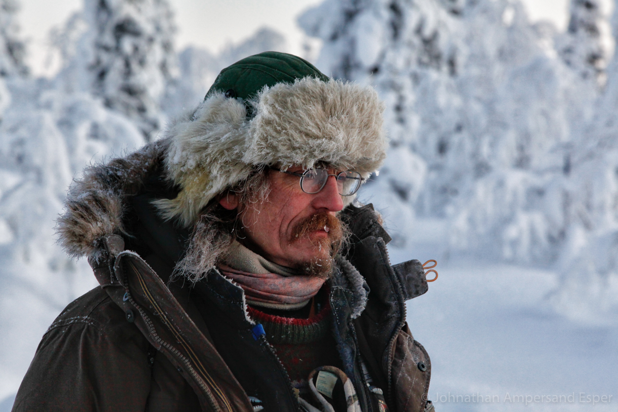 A dogsled guide gazes into the wintry wilderness. Captured on a 10 day dogsledding trip in -30 to -20 degree C temperatures near...