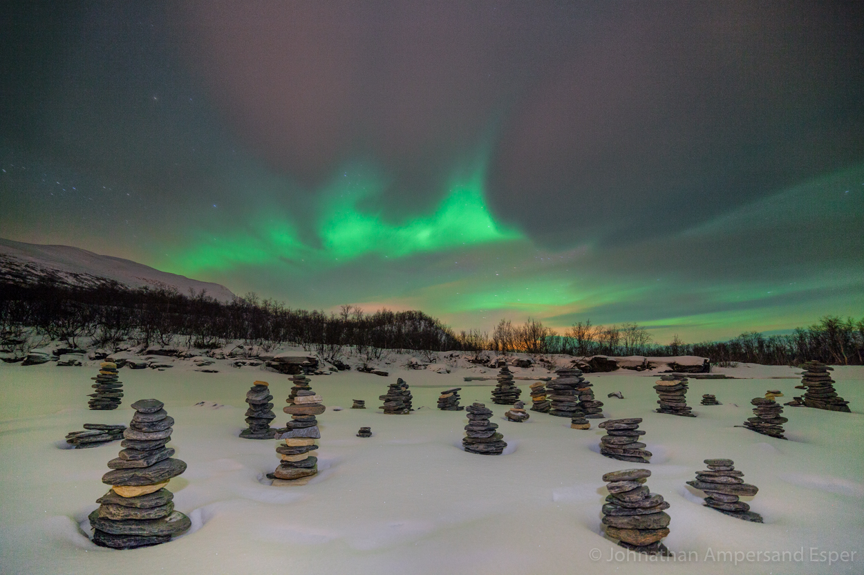 Aurora borealis display over cairn rock piles in Abisko, Sweden. Captured during a solo cross country skiing expedition on the...