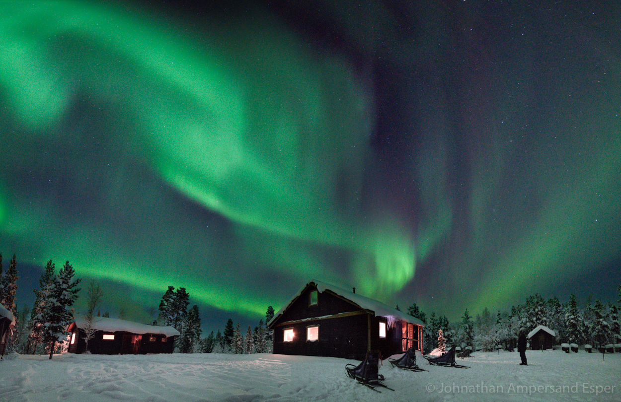 Aurora borealis over a cabin, while on a 10 day dogsledding trip in -30 to -20 degree C temperatures near Kiruna, Sweden.